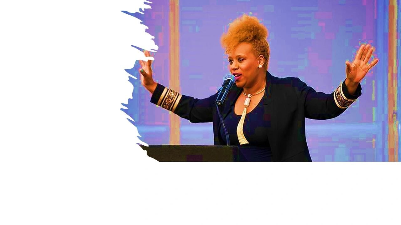 Timogi speaking on stage